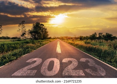Empty asphalt road and New year 2023 concept. Driving on an empty road to Goals 2023 with sunset. - Shutterstock ID 2169721235