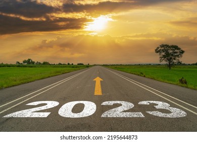 Empty asphalt road and New year 2023 concept. Driving on an empty road to Goals 2023 with sunset. - Shutterstock ID 2195644873