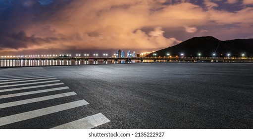 Empty asphalt road platform and mountain with cloud scenery at night - Powered by Shutterstock