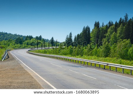 empty asphalt road with sharp turn