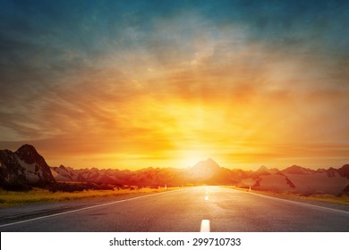 Empty Asphalt Road And Sun Rising At Skyline