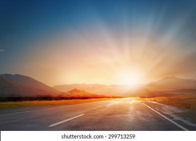 Empty Asphalt Road And Sun Rising At Skyline