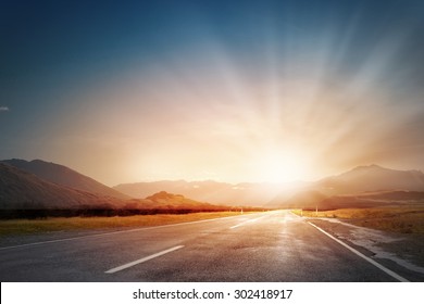 Empty Asphalt Road And Sun Rising At Skyline