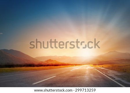Empty asphalt road and sun rising at skyline