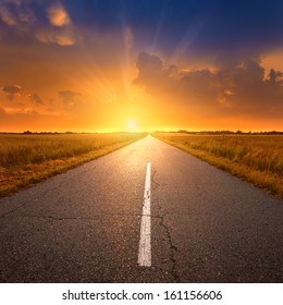 Empty Asphalt Road At Sunset