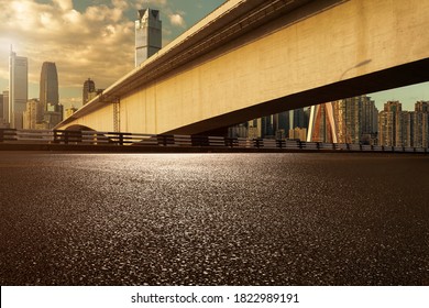 empty asphalt road under bridge in modern city