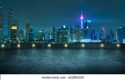 Empty Asphalt Roof Top With Modern City Skyline , Night Scene ,Kuala Lumpur , Malaysia .