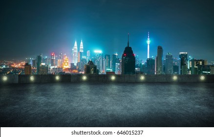 Empty asphalt roof top with modern city skyline , night scene ,Kuala Lumpur , Malaysia . - Shutterstock ID 646015237