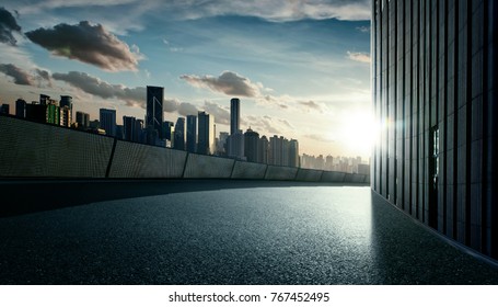 Empty Asphalt Street Road With Sunset City Skyline Background .