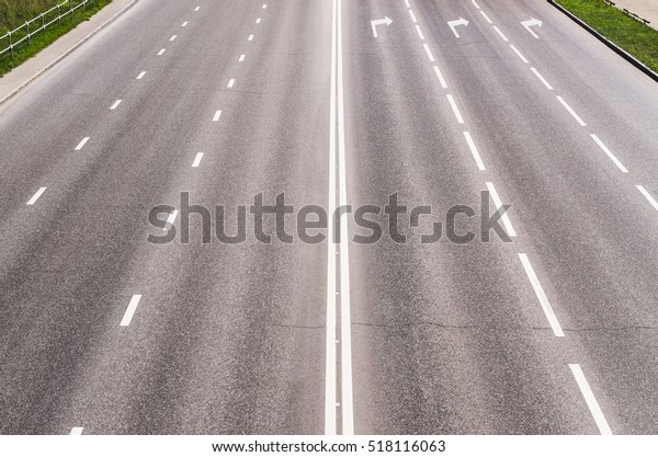 Empty asphalted highway with road markings,\
outgoing to perspective