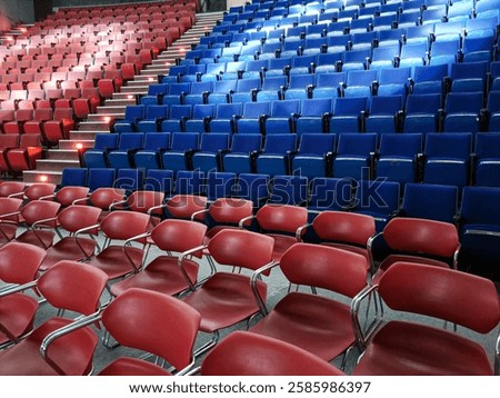 Empty Auditorium Seating Rows In An Interior Venue With Rows Of Blue And Red Chairs