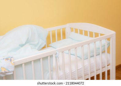 Empty Baby Cot With Bedding