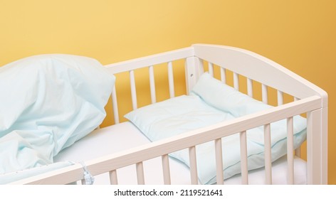 Empty Baby Cot With Bedding