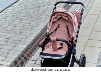 Empty Baby Stroller Near The Open Entrance To The Store.