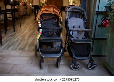 Empty Baby Stroller Near The Open Entrance To The Store.