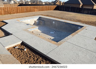 empty backyard swimming pool under construction