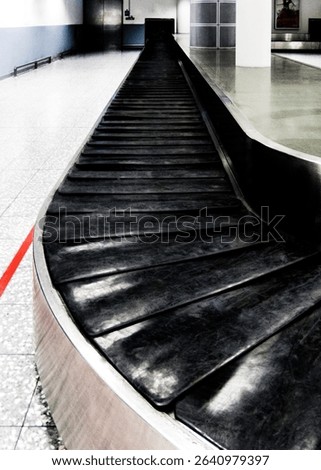 An empty baggage carousel in an airport.