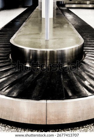 An empty baggage carousel in an airport.