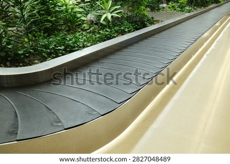 Empty Baggage Carousel at Airport. Empty baggage carousel inside a modern international airport, ready for arriving passengers and their luggage. Neutral travel concept illustrating airport infrastructure, arrivals, departures, transit, baggage handling, and the beginning or end of a journey.