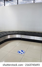 Empty Baggage Carousel At The Airport With A Step Sticker On The Floor