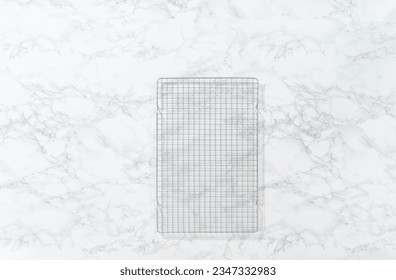 Empty baking drying rack on a marble surface.