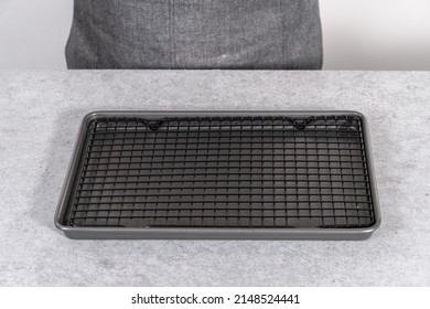 Empty Baking Sheet With Wire Rack On A Gray Background.