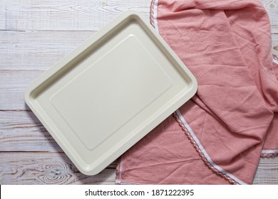 Empty Baking Tray With Pink Tablecloth Top View On Table