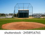 Empty baseball diamond with backstop and pitcher