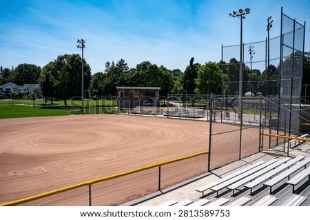 Empty baseball diamond viewed from stadium bleachers.