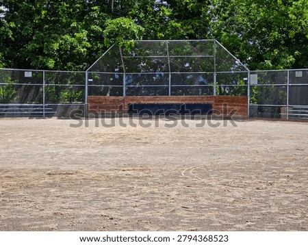 Empty Baseball Field Backstop and Dirt Infield at Community Sports Park