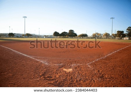 Empty baseball field view from home plate, late afternoon light
