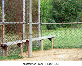 Empty Baseball & Softball Bench within a Fence