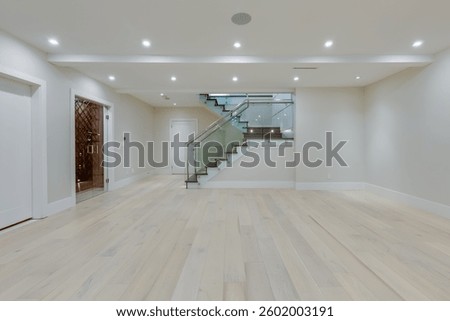 Empty basement in a newly built house with stairs 