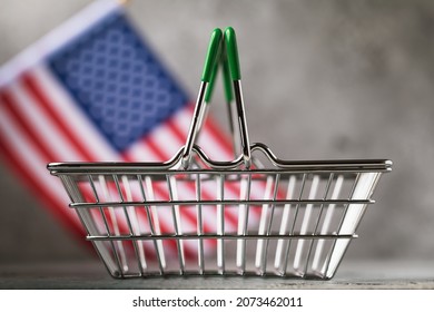 Empty Basket For Products On The Background Flag Of The United States Of America, The Concept Of The Food Crisis