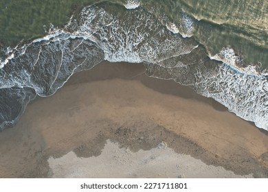 Empty beach on sunset time aerial above drone view