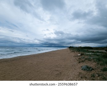 Empty beach under a cloudy sky.