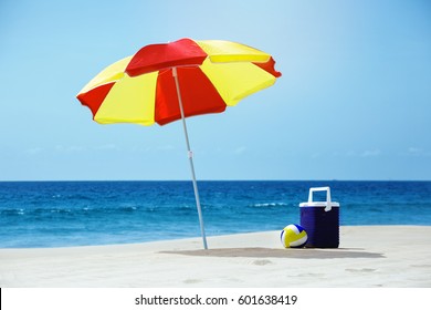 Empty beach without people with umbrella and accesorries at sea background - Powered by Shutterstock