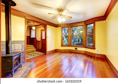 Empty beautiful living room with wood burning stove. Old American craftsman style home with lots of wood details.