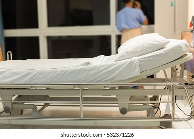 Empty Bed In The Room Hospital, Blurred Background Of Patient.