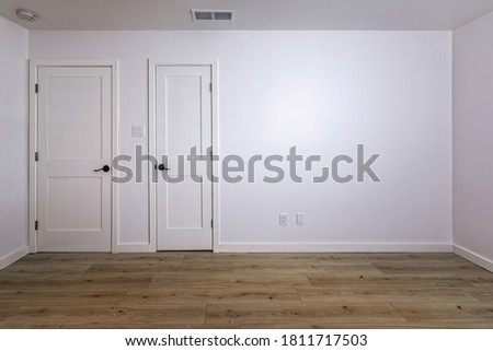 Empty bedroom with open doors leading to the livingroom, bathroom and a closet