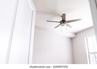 Empty bedroom room interior nobody looking up at ceiling fan open door in new modern luxury apartment home house with window bright light