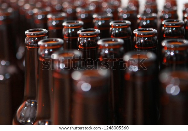 Empty beer bottles. One bottle in focus. All\
the other bottles are out of focus. Private beer factory. Beer from\
natural products.