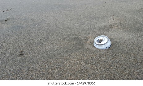 An Empty Beer Can Buried In The Sand On A California Beach, Litter.