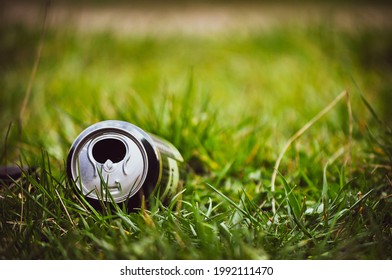 Empty beer can. Trash in the grass	