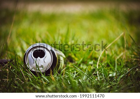 Empty beer can. Trash in the grass	