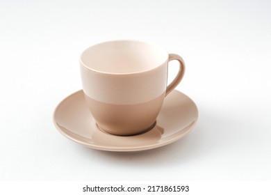 Empty beige coffee ceramic cup and saucer on isolated white background, cut out.