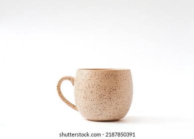 Empty beige coffee ceramic cup on isolated white background, cut out.