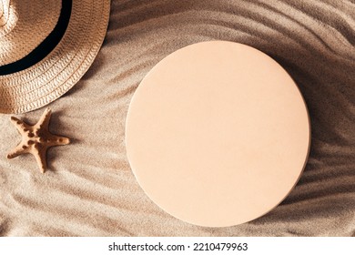 Empty beige round platform podium mockup for beauty cosmetics or products presentation. Straw hat and sea star on natural white beach sand background. Top view - Powered by Shutterstock