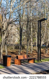 Empty Bench In The Alley Of The City Park. Empty Park Bench. . High Quality Photo