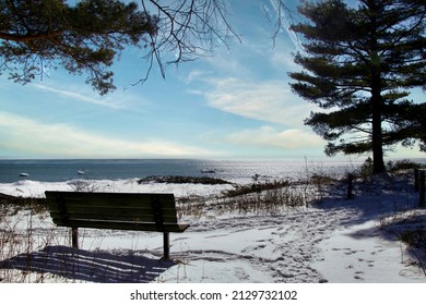 Empty Bench Along Frozen Lake Michigan Shoreline